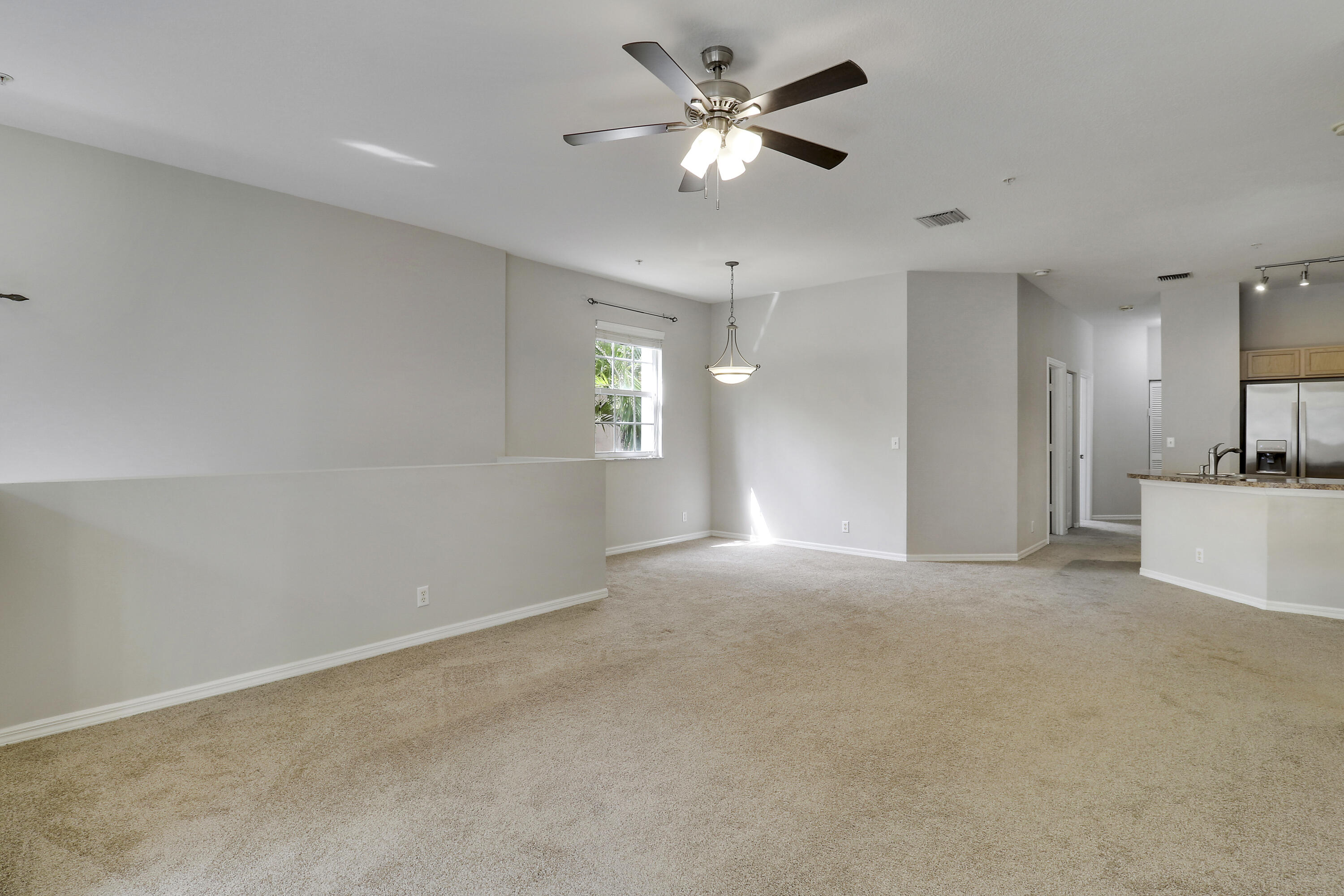 104 Lighthouse Circle, Unit H2 Tequesta, FL 33469 - Photo 9 of 45 a view of an empty room with a ceiling fan and window
