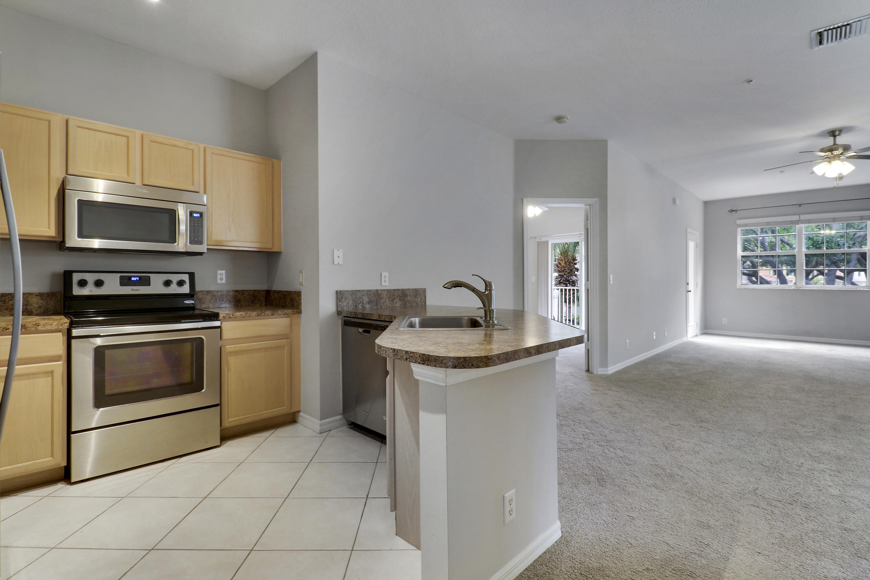 104 Lighthouse Circle, Unit H2 Tequesta, FL 33469 - Photo 10 of 45 a kitchen with a stove and a microwave