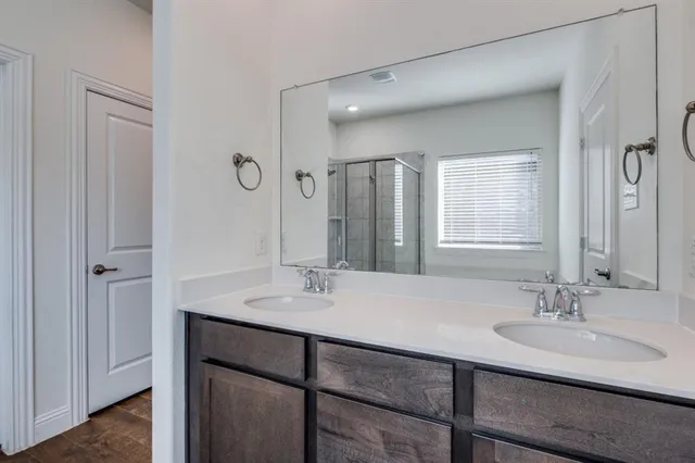 a bathroom with a sink double vanity and a mirror