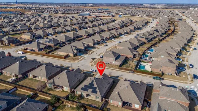 an aerial view of a houses with city street
