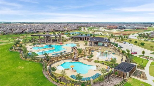 an aerial view of a swimming pool with a table and chairs