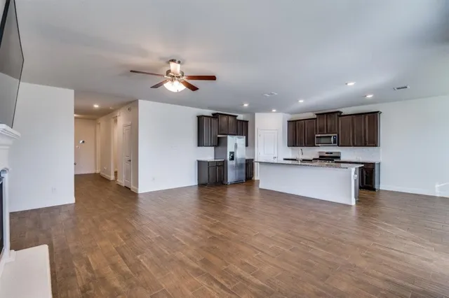 a view of kitchen with cabinets appliances and wooden floor