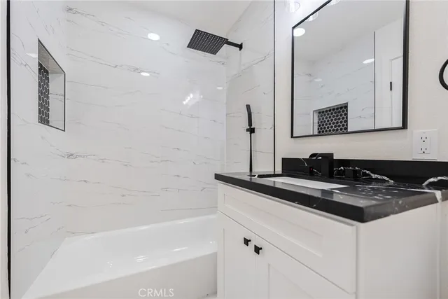 a bathroom with a bathtub and a sink