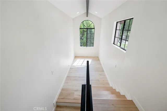 a view of entryway and hall with wooden floor