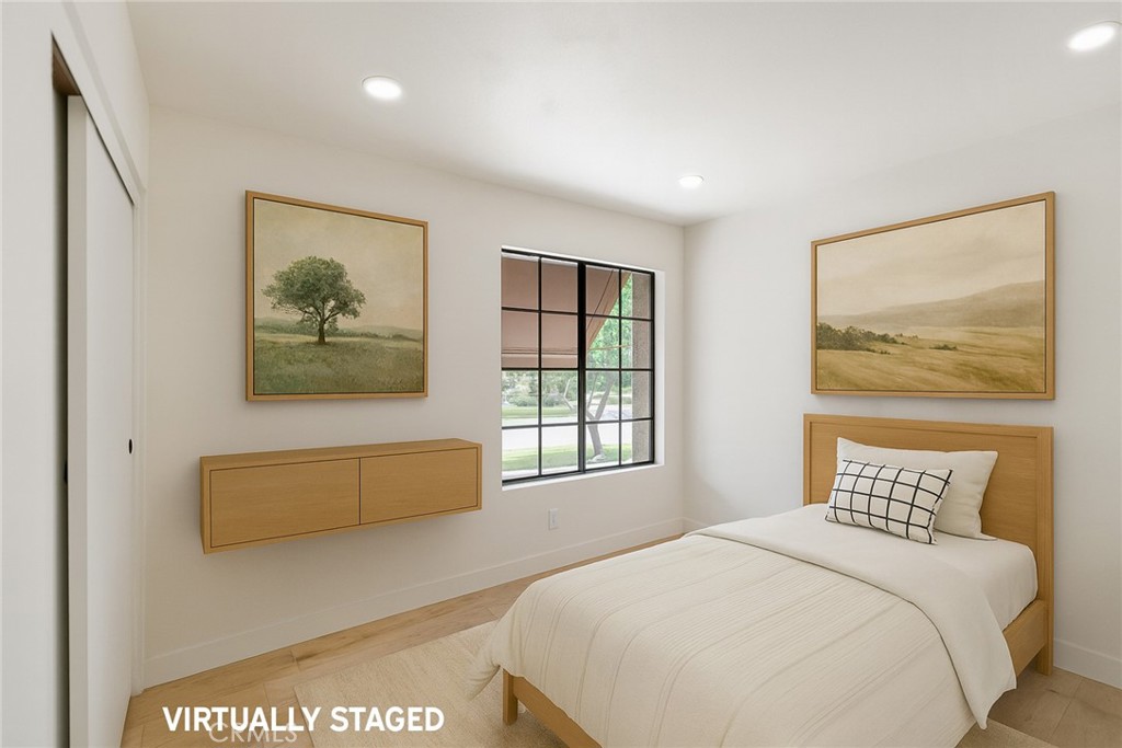 7 Wilderness Place Phillips Ranch, CA 91766 - Photo 19 of 25 a bedroom with a bed and a painting on the wall