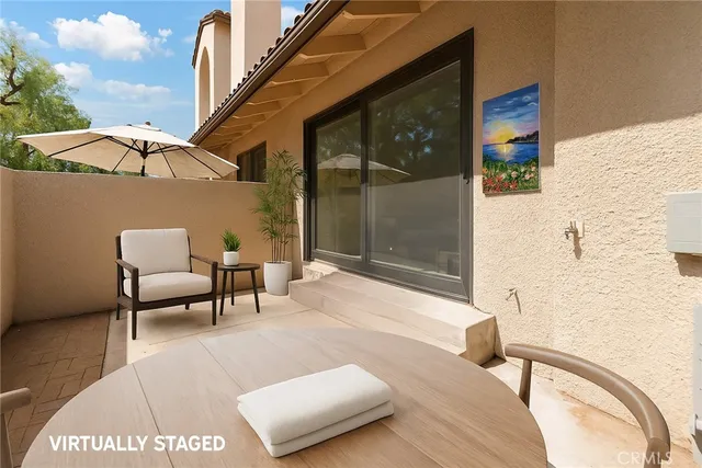 a balcony with furniture and a potted plant
