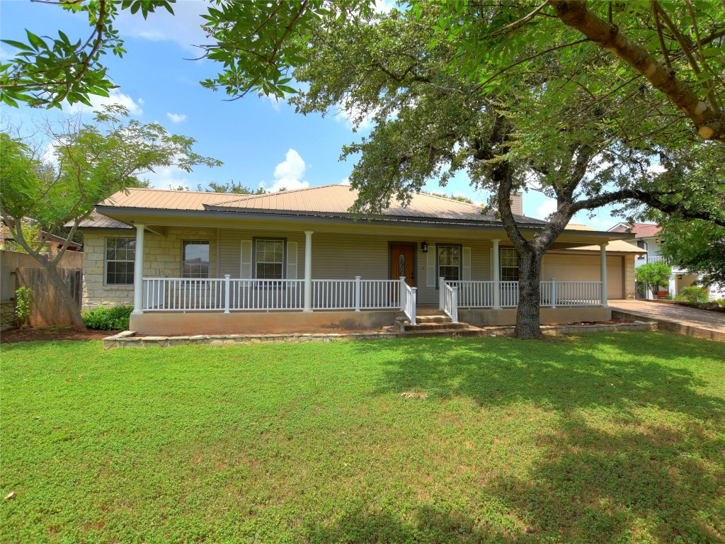 a front view of a house with a garden and porch