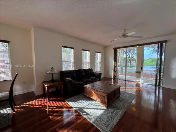 a living room with furniture and wooden floor
