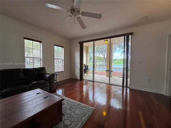 a view of a living room and floor to ceiling window