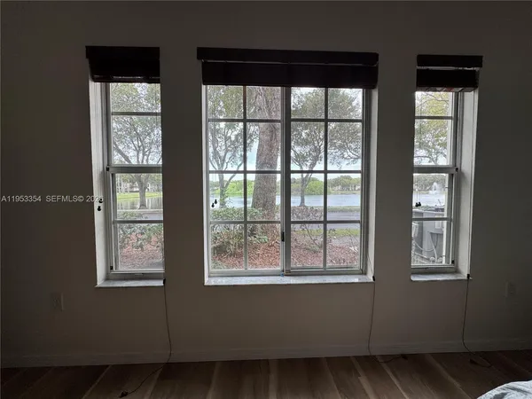 a spacious bedroom with a bed and a window