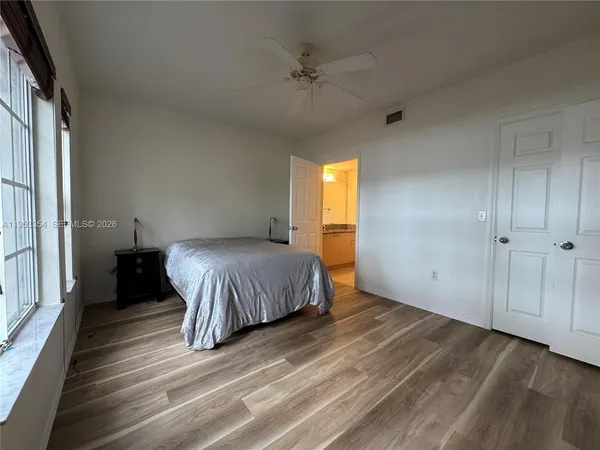 a spacious bedroom with a bed and a window