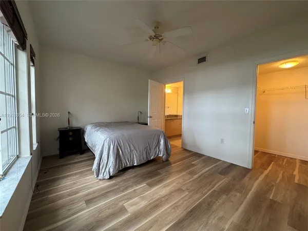 a spacious bedroom with a bed and a window