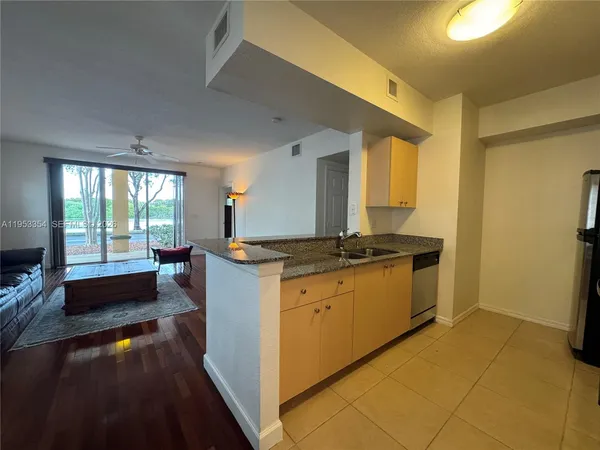 a kitchen with a refrigerator and a sink