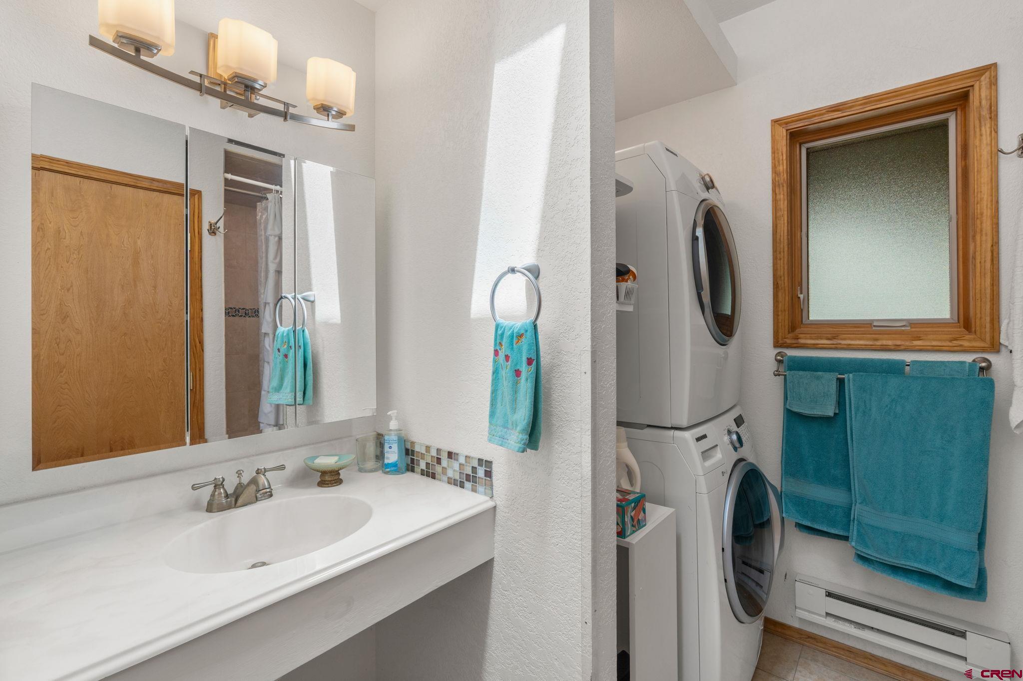 37 Verde Lane Durango, CO 81301 - Photo 39 of 45 a bathroom with a sink a mirror and shower