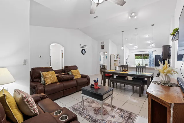 a bedroom with a bed and a dresser with a chandelier