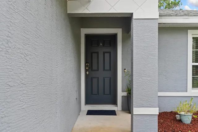 a bedroom with a bed next to a window
