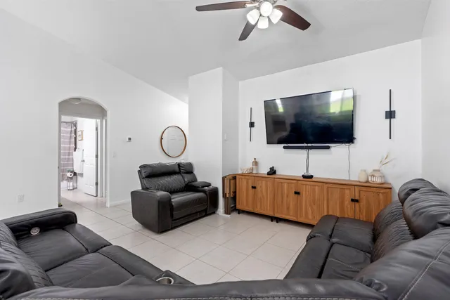 a bathroom with a granite countertop sink a toilet a shower and a mirror