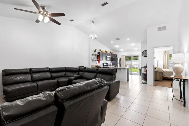 a view of a patio with table and chairs and potted plants