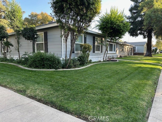 2550 4th Avenue Merced, CA 95340 - Photo 33 of 35 a front view of a house with a garden and trees
