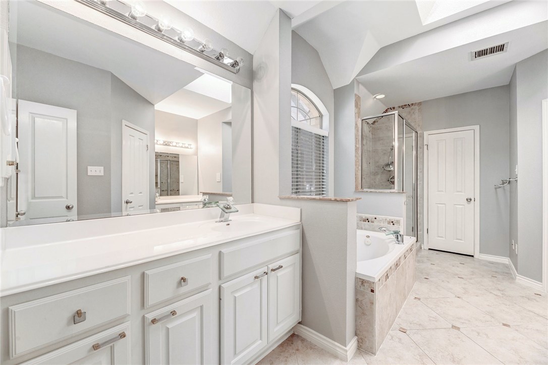 9404 Temecula Pass Austin, TX 78717 - Photo 15 of 31 Master ensuite bathroom has two vanities, a jetted tub, separate shower and private toilet. Large walk in closet.