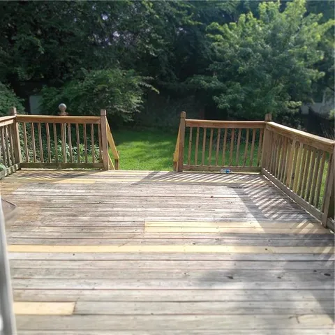 a view of backyard with deck and hardwood