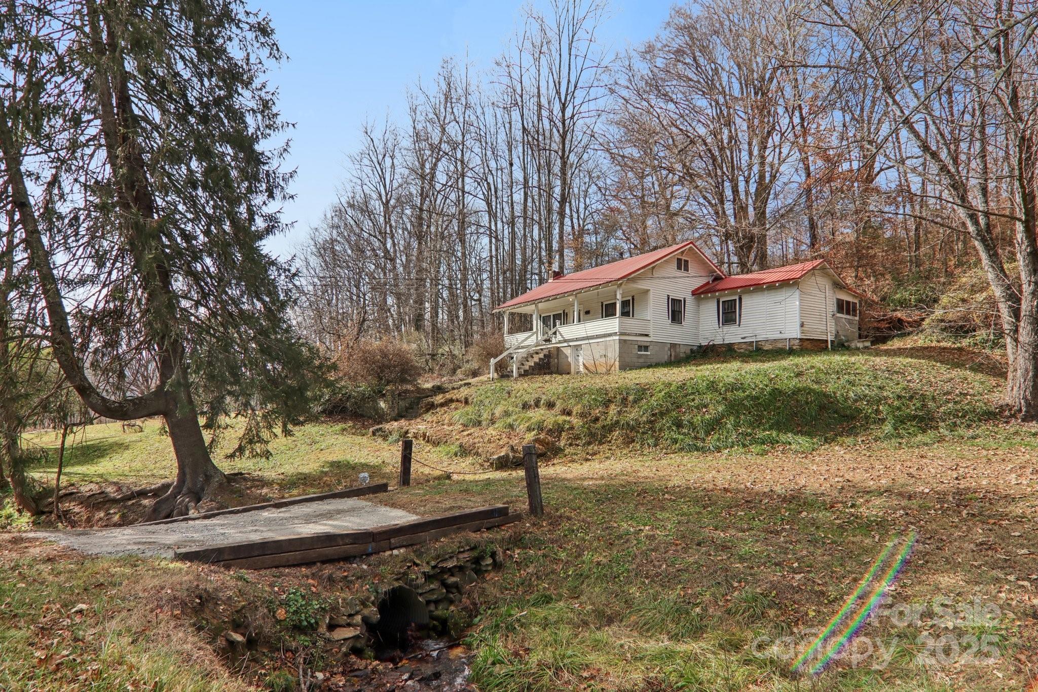 a view of a house with large trees