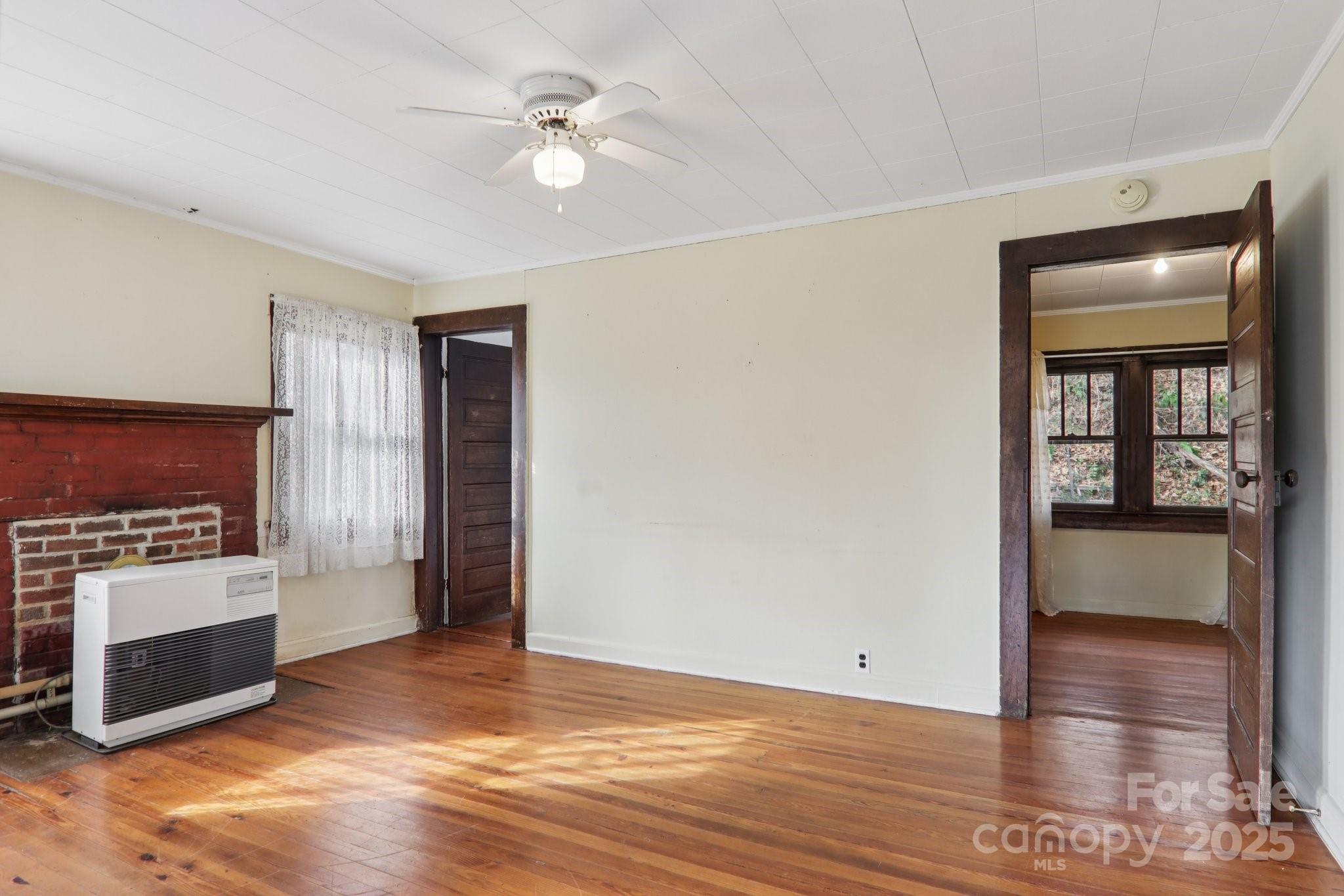 301 Parris Branch Road Sylva, NC 28779 - Photo 11 of 30 a view of a livingroom with an empty space and a fireplace
