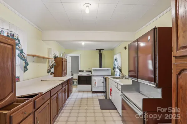 a large kitchen with a large counter top space appliances and cabinets