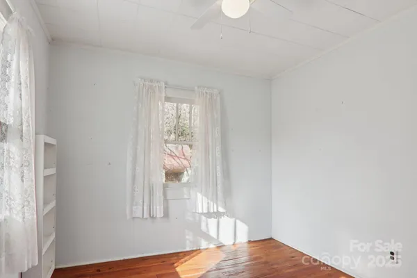 a view of bedroom with wooden floor