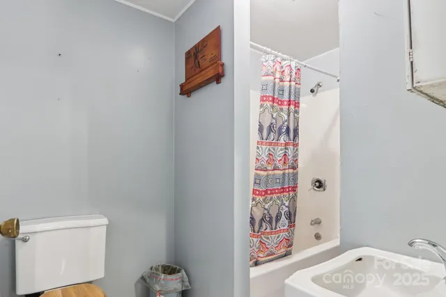 a bathroom with a shower and a sink