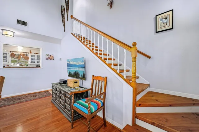 a room with stairs and a wooden floor