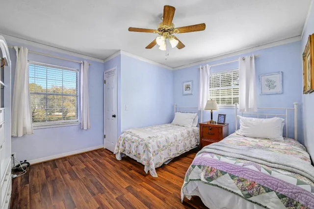 a bedroom with two beds and a large window