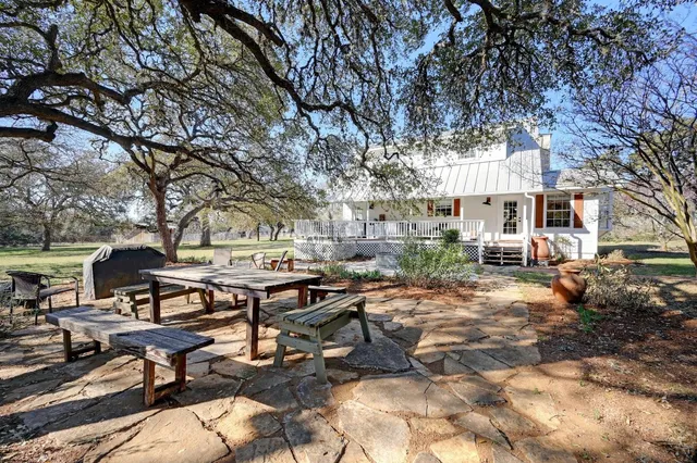 a view of a patio with table and chairs and couches
