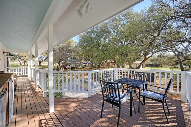 a view of balcony with furniture and wooden deck