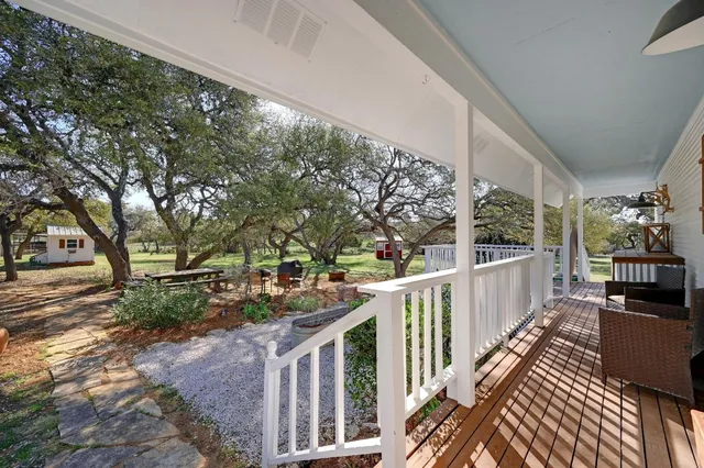a view of a house with backyard and sitting area