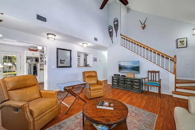 a living room with furniture and a wooden floor