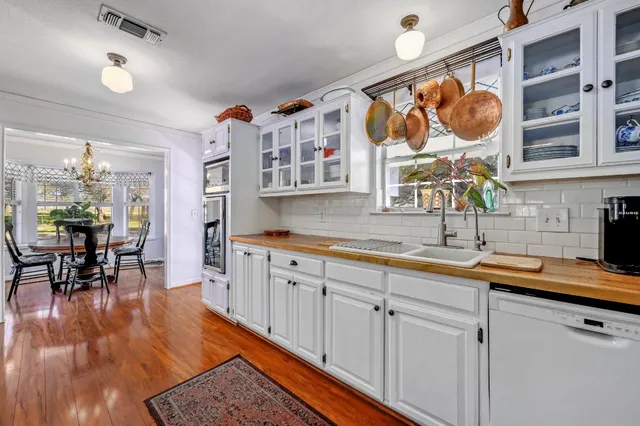 a kitchen with stainless steel appliances granite countertop a sink and cabinets