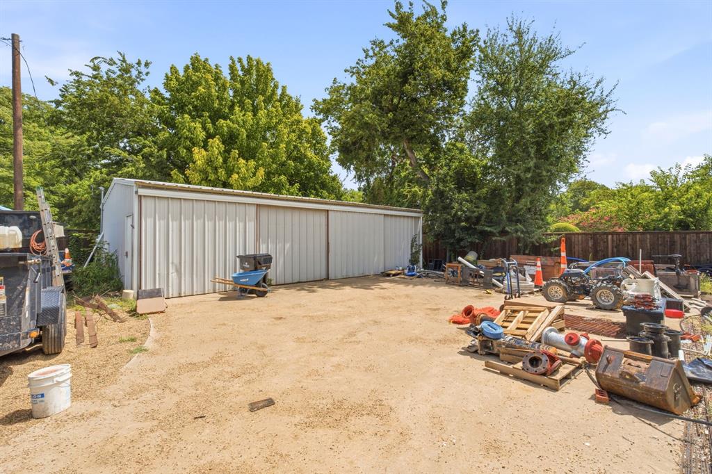 9780 North County Road Frisco, TX 75033 - Photo 31 of 37 super rare metal insulated shop with hangar style doors! storage for loads of cars or toys and a fenced yard