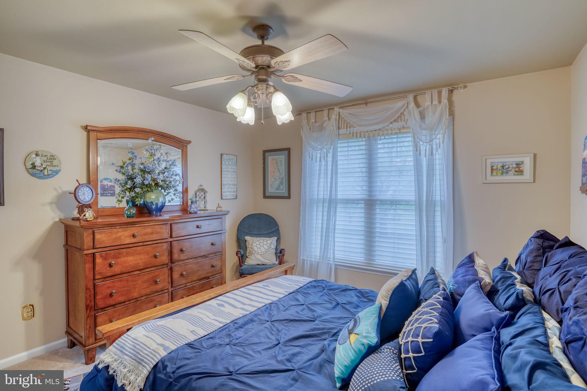357 Willits Way Garnet Valley, PA 19060 - Photo 45 of 63 a bedroom with a bed and a chandelier