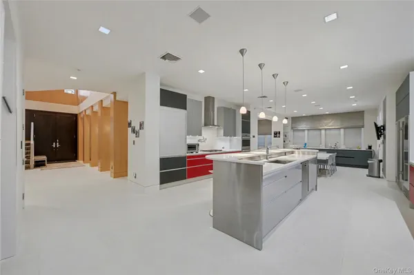 a kitchen with stainless steel appliances granite countertop a sink and a refrigerator
