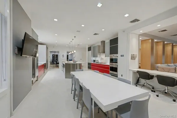 a kitchen with stainless steel appliances a stove and white cabinets