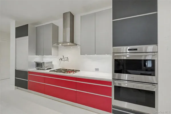 a kitchen with a dining table chairs sink and stove