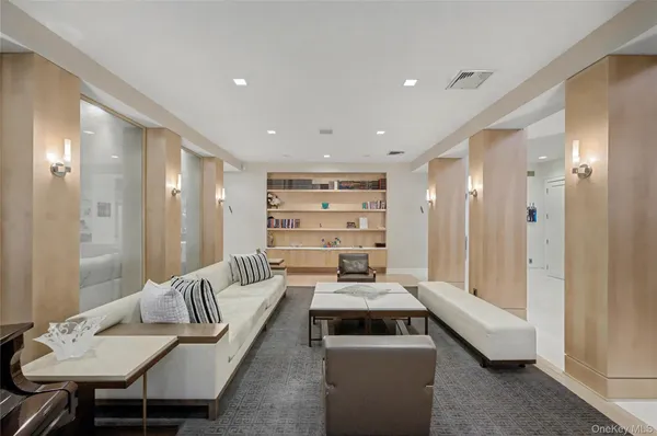 a dining room with furniture a chandelier and wooden floor