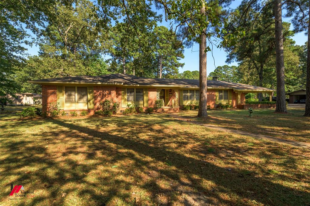 205 7th Street Northeast Springhill, LA 71075 - Photo 1 of 40 Brick exterior with yellow window shutters, covered front entry, and mature trees