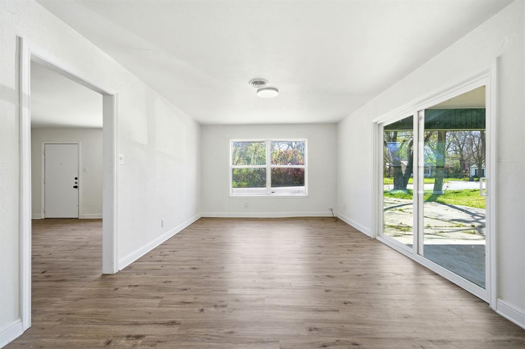 619 9th Street Terrell, TX 75160 - Photo 11 of 24 an empty room with wooden floor and windows