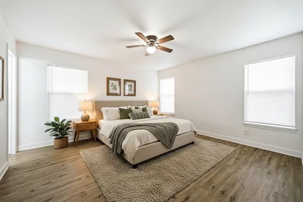 a bedroom with a bed and a potted plant