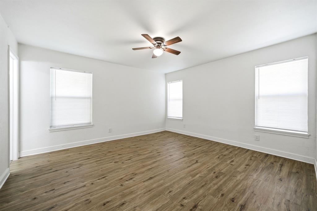 619 9th Street Terrell, TX 75160 - Photo 13 of 24 a view of empty room with wooden floor and fan