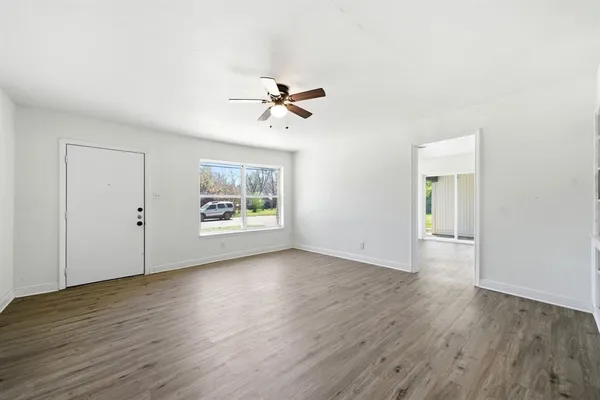 wooden floor in an empty room with a window