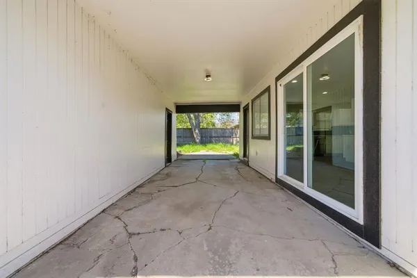a view of an empty room with glass door