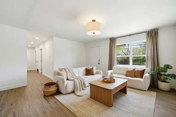 a living room with furniture and a large window